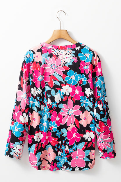 Rosa Bluse mit V-Ausschnitt und Rolllaschenärmeln und Blumenmuster