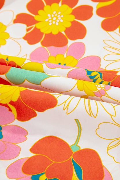 Orangefarbene Bluse mit V-Ausschnitt und halblangen Ärmeln und abstraktem Print
