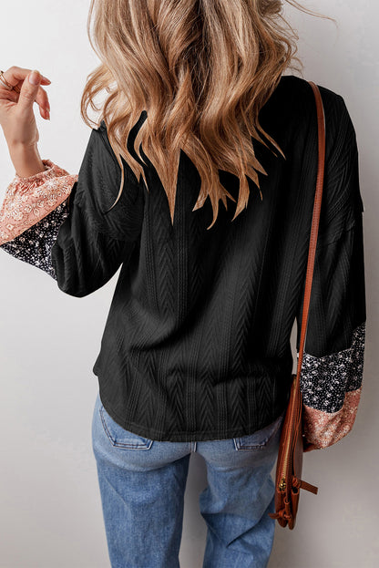 Schwarze Bluse mit V-Ausschnitt und floralem Patchwork-Muster