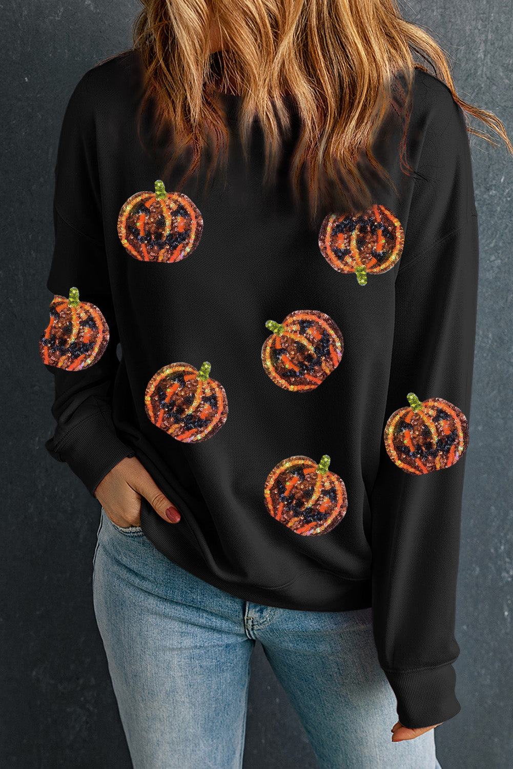 Schwarzes Pullover-Sweatshirt mit Halloween-Kürbis-Grafik und Pailletten