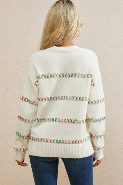 Weißer Pullover mit bunten Kreuzstichen und überschnittenen Schultern