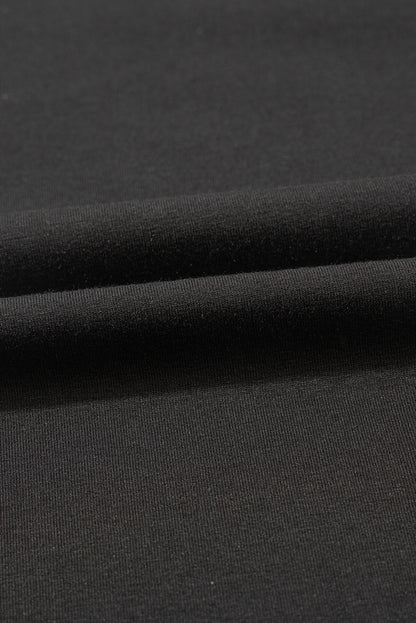 Schwarzes Oversize-Oberteil mit kontrastierendem Blumenmuster und Puffärmeln