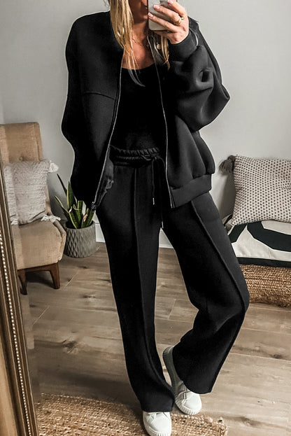 Schwarzes Set mit Jacke mit durchgehenden Nähten und Reißverschluss und Hose mit Kordelzug in der Taille