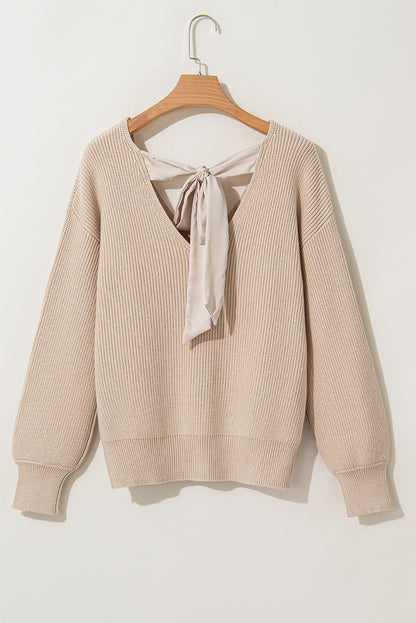 Aprikosenfarbener Pullover mit Laternenärmeln und V-Ausschnitt und Knoten hinten