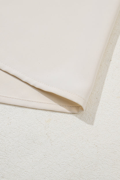 Haferflockenfarbenes Patchwork-Oberteil mit V-Ausschnitt und geometrischem Kontrastdruck in Übergröße