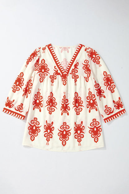 Orangefarbene Bluse mit 3/4-Ärmeln und V-Ausschnitt im Vintage-Stil mit geometrischem Muster