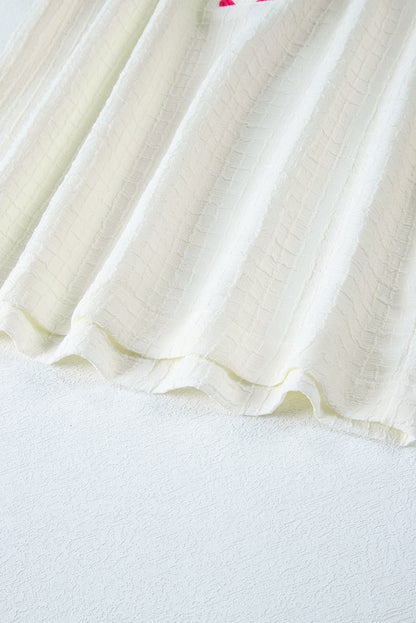 Beigefarbene Bluse mit floraler Stickerei und strukturierten Puffärmeln im Ricrac-Stil