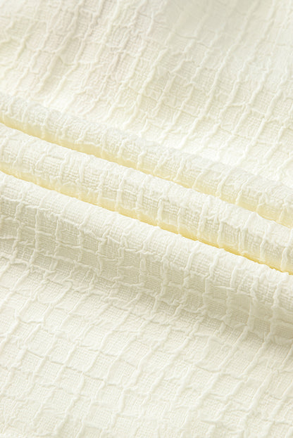 Beigefarbene Bluse mit floraler Stickerei und strukturierten Puffärmeln im Ricrac-Stil