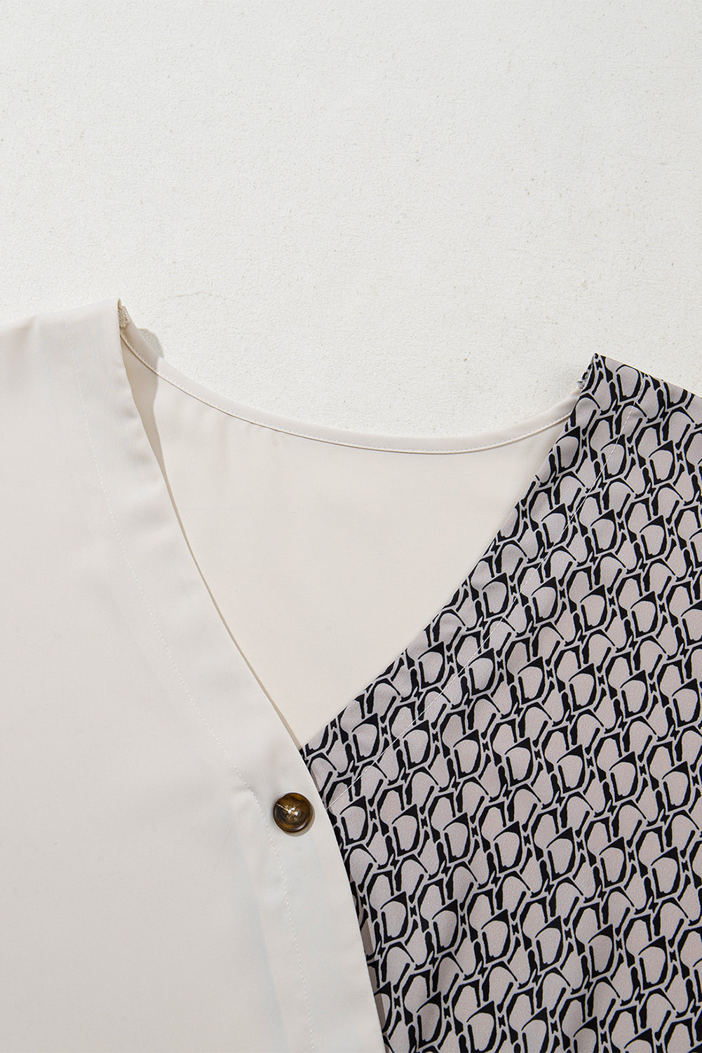 Haferflockenfarbenes Patchwork-Oberteil mit V-Ausschnitt und geometrischem Kontrastdruck in Übergröße