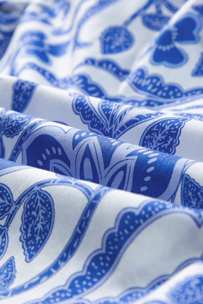 Dunkelblaue Bluse mit Blumenmuster und Rüschen und Puffärmeln