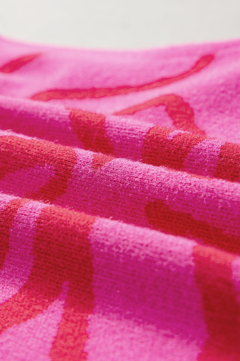 Ärmelloses Stricktop mit Blumenmuster und Knopfleiste in leuchtendem Pink