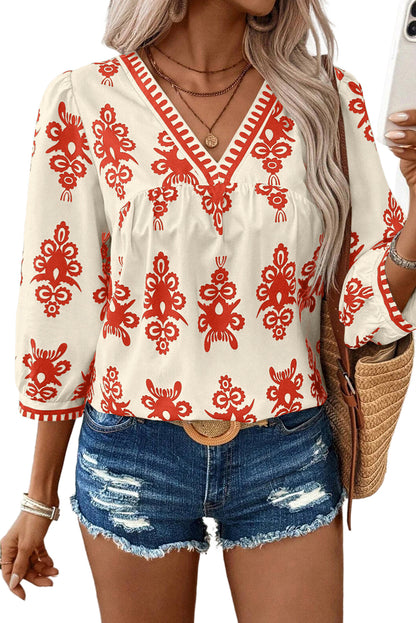 Orangefarbene Bluse mit 3/4-Ärmeln und V-Ausschnitt im Vintage-Stil mit geometrischem Muster