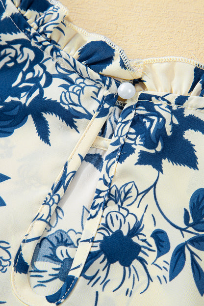 Himmelblaue Bluse mit Blumenmuster, Volantärmeln und Schlüsselloch hinten