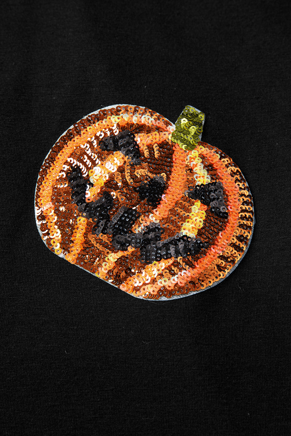 Schwarzes Pailletten-Kürbisgesicht-Halloween-T-Shirt