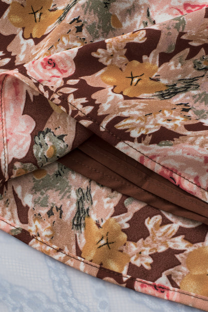 Rosa Bluse mit Blumenmuster und Ballonsaum und Schlitz am Ausschnitt