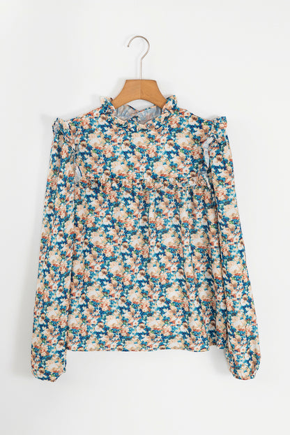 Himmelblaue Bluse mit Blumenmuster, Rüschen und Stehkragen sowie Puffärmeln