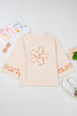 Beiges Plus Size Top mit Rundhalsausschnitt und Blumenpatches
