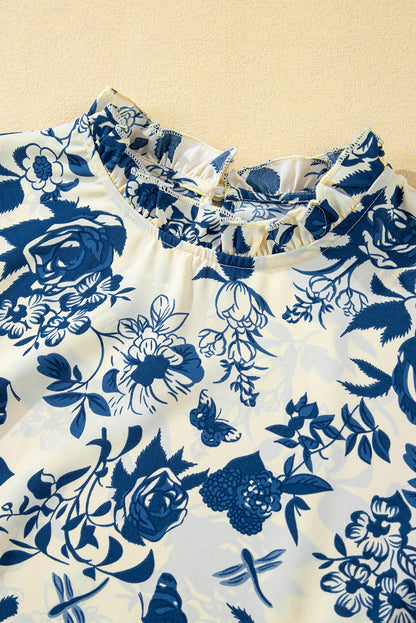 Himmelblaue Bluse mit Blumenmuster, Volantärmeln und Schlüsselloch hinten