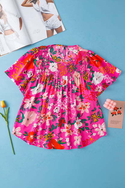 Rosa, gesmoktes, kurzärmliges Blusenkleid mit Blumenmuster