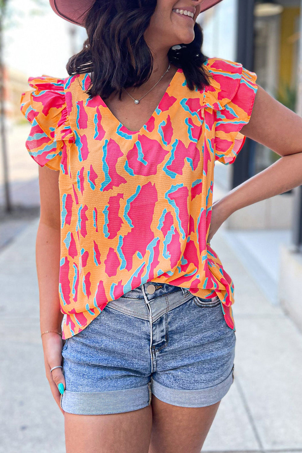 Orangefarbene Bluse mit abstraktem Print und V-Ausschnitt und Rüschenärmeln
