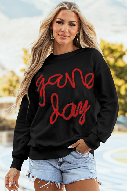 Schwarzes Lametta-Sweatshirt mit Game Day-Grafik und überschnittener Schulter