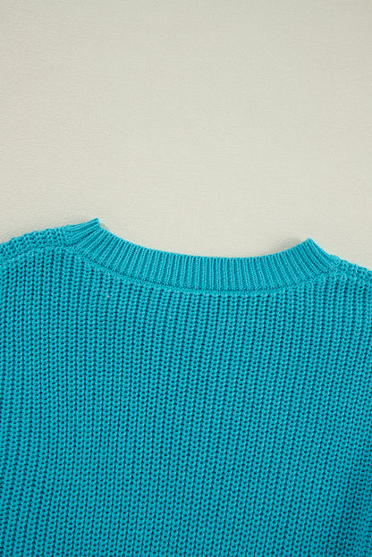 Türkisfarbener Pullover mit gerüschten Ösenärmeln